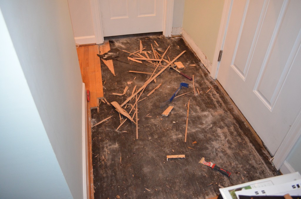 Removing existing hardwood floors.