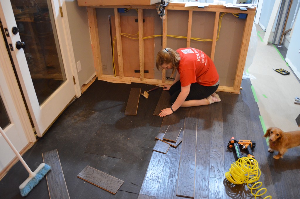Ashley finishing the flooring in the dining room.